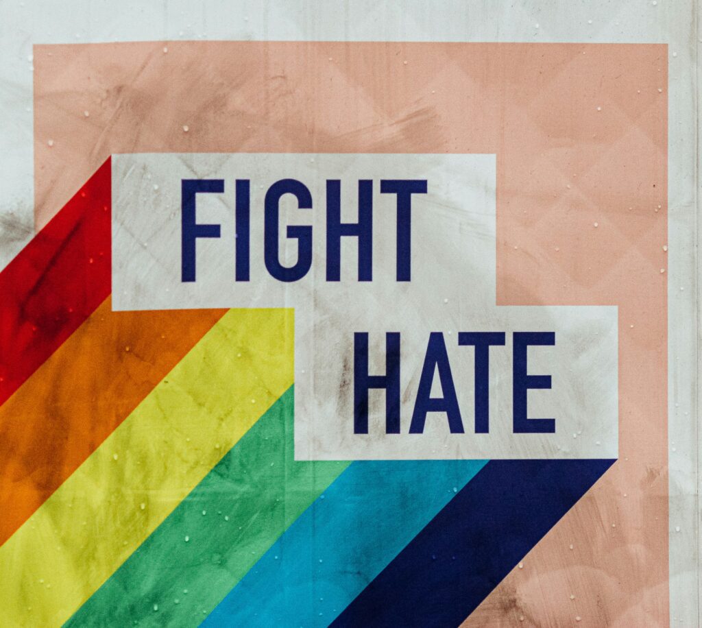 Fight Hate with rainbows trailing, call to stand against bigotry
