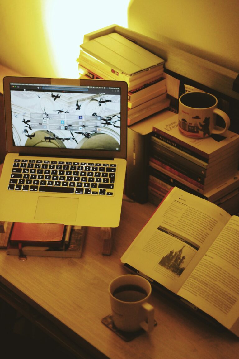 Computer, books, and resources on desk--resources for those exploring faith and Progressive Christianity